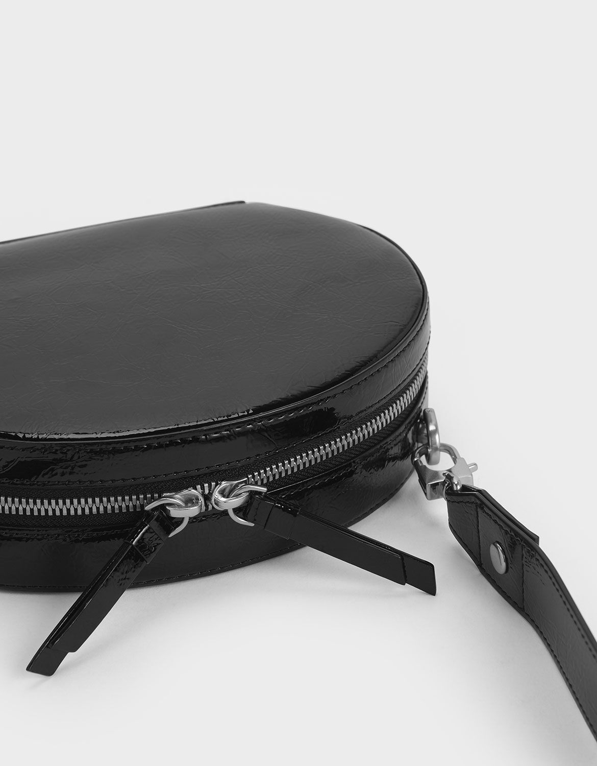 Black Wrinkled Patent Oval Crossbody Bag | CHARLES & KEITH EU