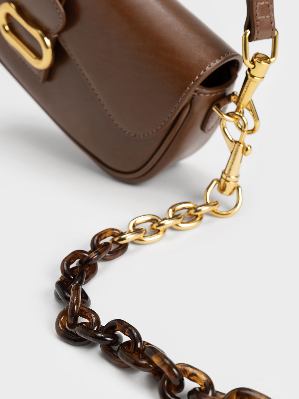 Chocolate Daki Belted Curved Bag - CHARLES & KEITH FR