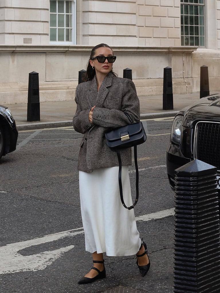 Women’s Toni knotted curved hobo bag in noir & Robbie platform knee-high boots in black, as seen on Fleur Raffan - CHARLES & KEITH