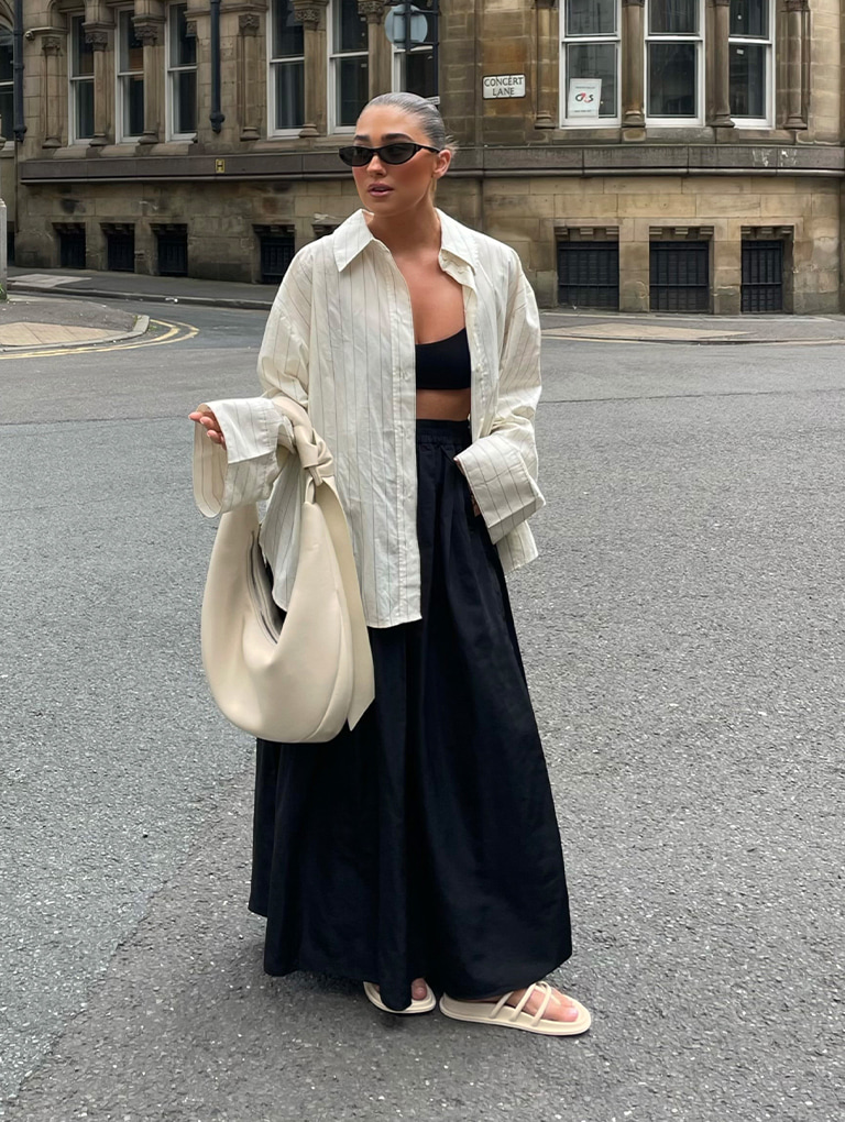 Women’s Toni Knotted Curved Hobo Bag in chalk and Recycled Acetate Angular Shield Sunglasses in black, as seen on Hannah Whiting – CHARLES & KEITH