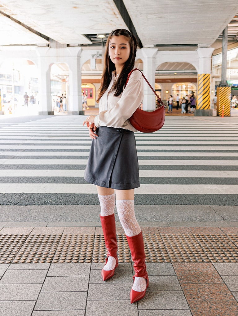 Women’s asymmetrical saddle bag in red & Robbie cut-out pointed-toe knee-high boots in red, as seen on Kanon - CHARLES & KEITH