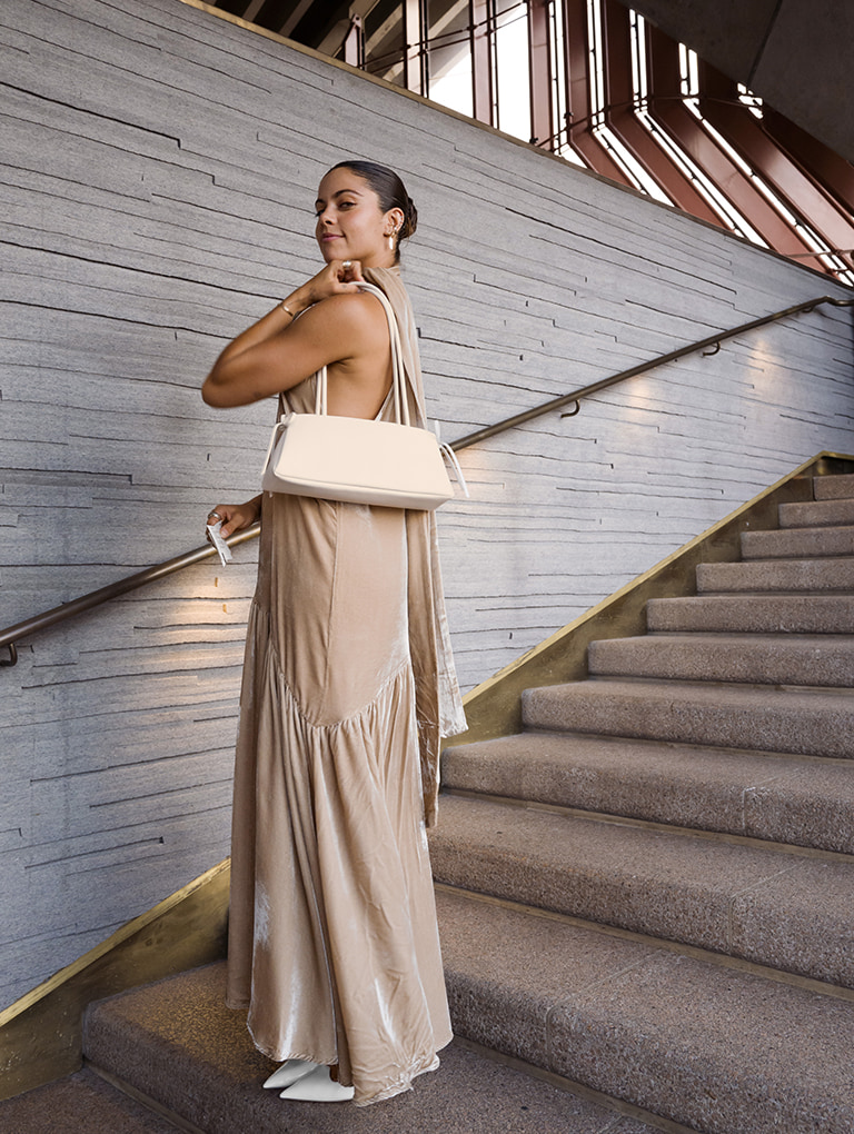 Women’s pointed-toe Mary Jane slingback pumps in white & bow elongated trapeze shoulder bag in meringue white, as seen on Mimi El-Ashiry – CHARLES & KEITH