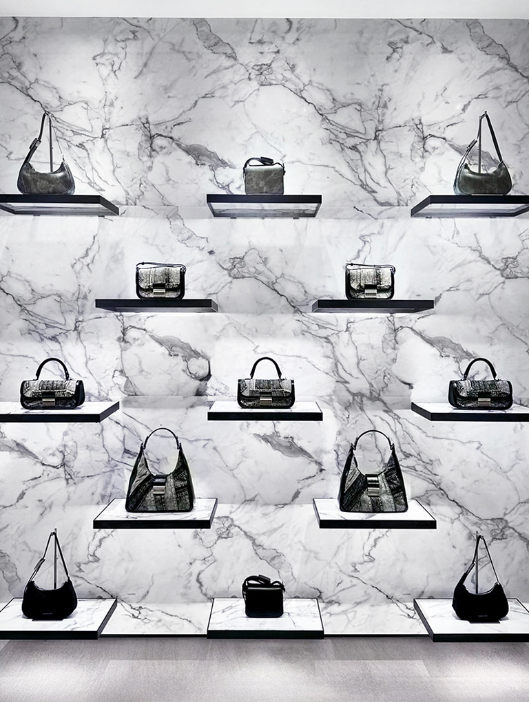 Nylon curved metallic-accent shoulder bag in noir; Denim curved metallic-accent shoulder bag in dark grey; Charlot patchwork denim bag in noir; Charlot elongated top handle bag in noir; Charlot patchwork denim hobo bag in noir; Denim boxy front flap shoulder bag in dark grey and boxy front flap shoulder bag in jet black — CHARLES & KEITH